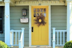 welcoming Front door entrance painted a bright yellow